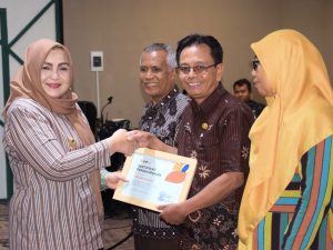 Wakil Bupati Banyumas Dwi Asih Lintarti berjabat tangan dan menyerahkan sertifikat penghargaan koperasi pada Resepsi Harkopnas ke-79 di Purwokerto.